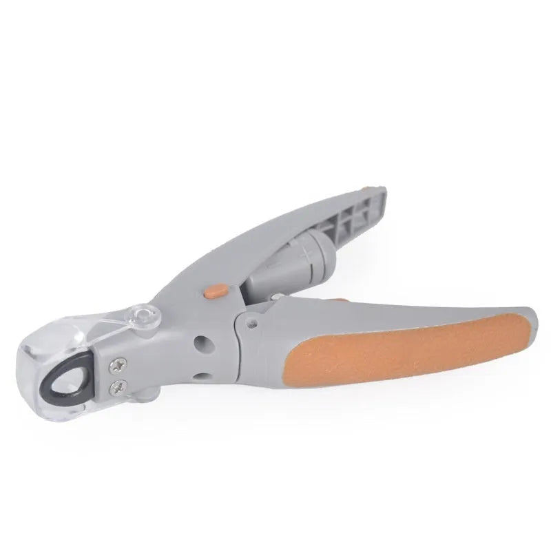 White plastic dog nail clipper with built-in LED light and red guide line on a blister card.