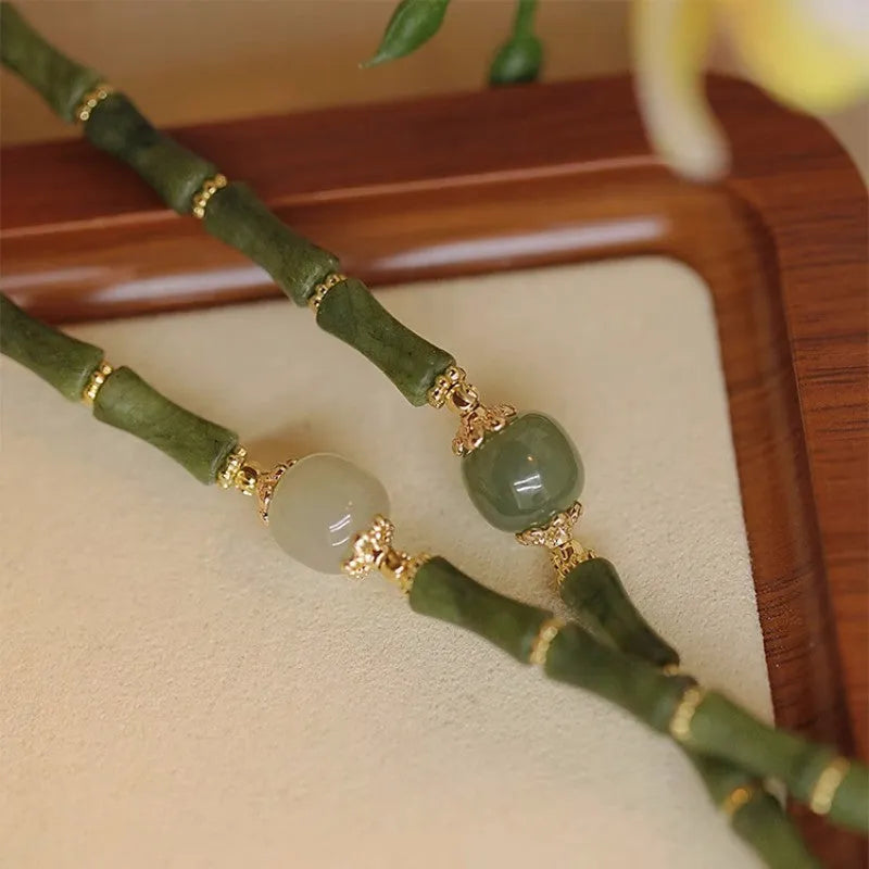 A geometric beaded bracelet made from dark green Hetian jade for women, showing a simple round style.