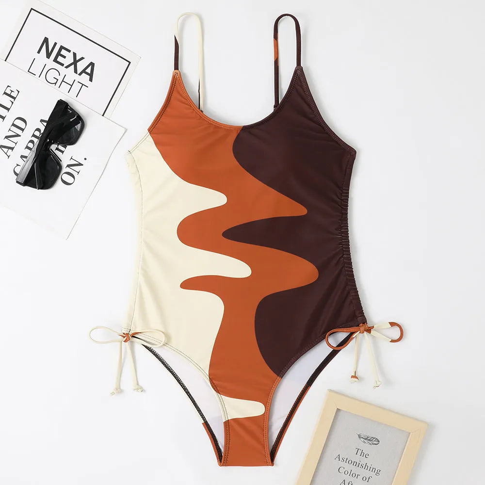 Women's sleeveless one-piece swimsuit in blue with backless design and striped pattern