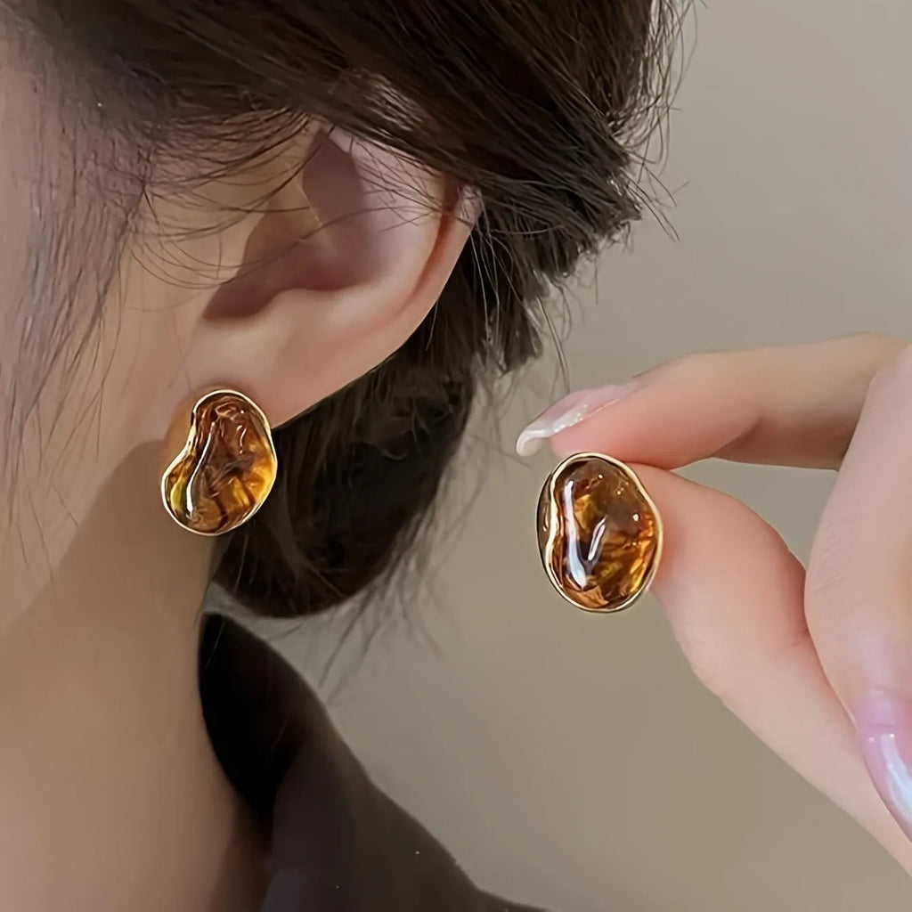 Three pairs of geometric alloy ear rings with tassel elements in different electroplated finishes