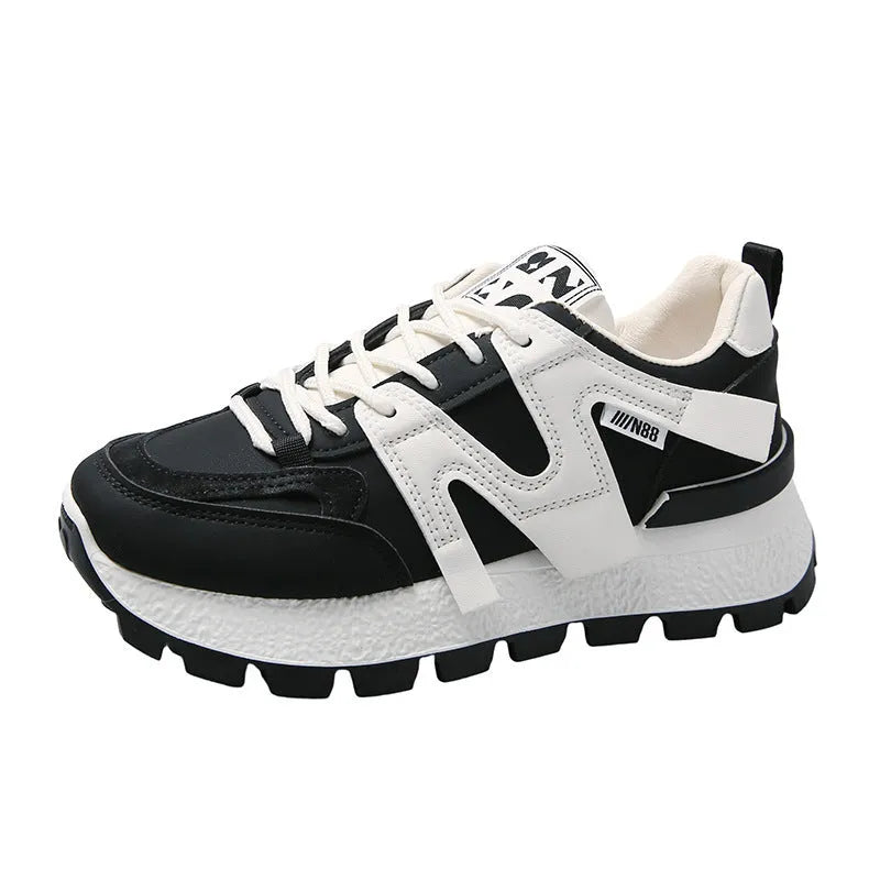 Unisex low-top running sneaker in black with round toe, lace-up front, and rubber sole on a white background.