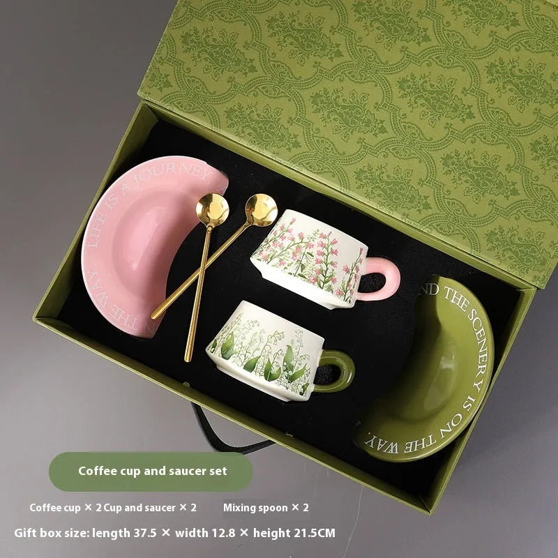 Ceramic coffee cup and saucer set with two cups, two saucers, and two stirring spoons