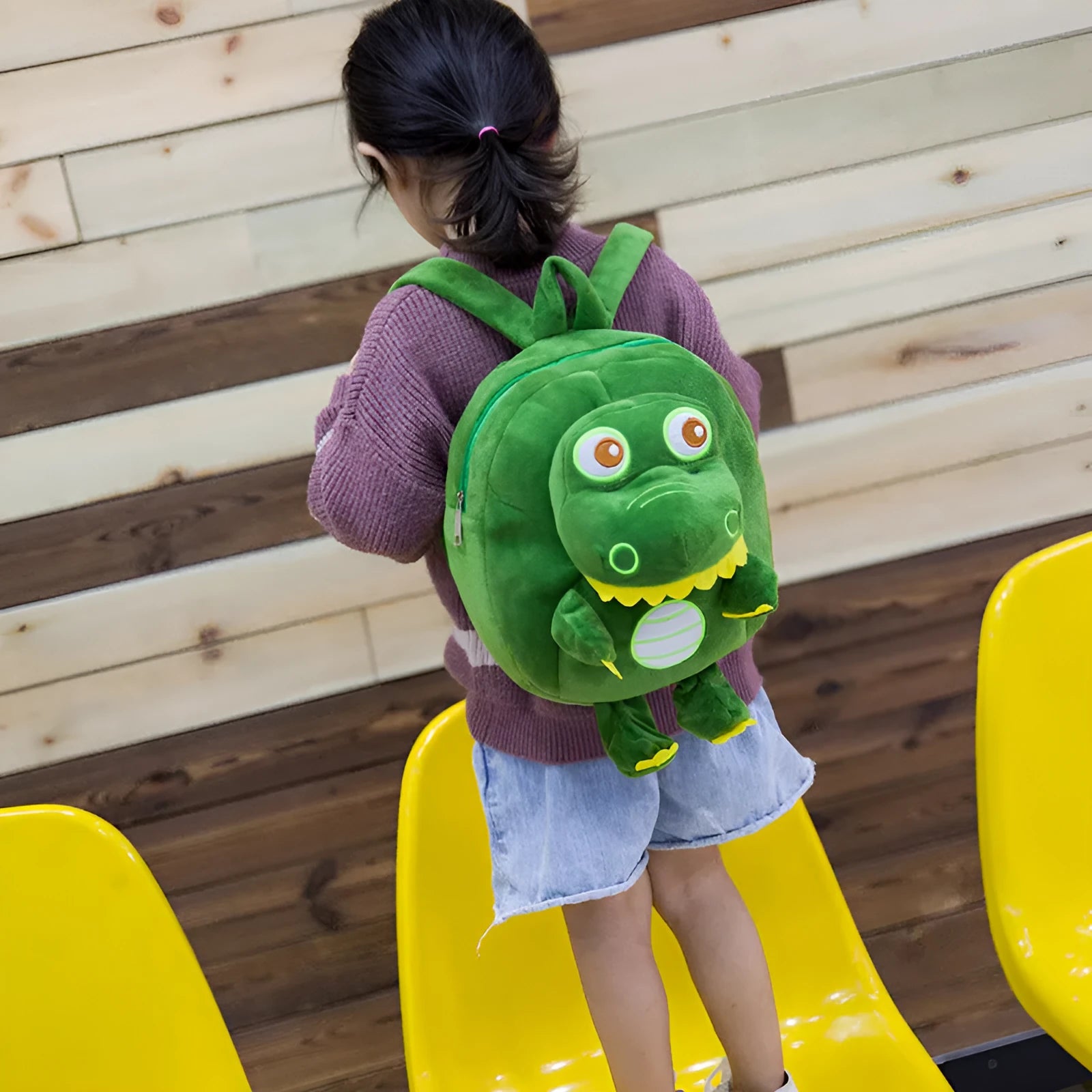 Dinosaur plush toy backpack for children with embroidery detailing and soft handle in blue colour