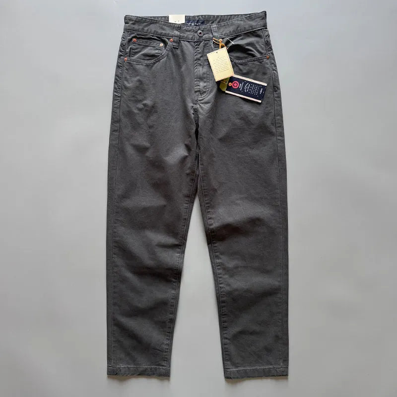 Men's grey straight-leg cotton casual trousers laid flat, showing mid-waist and inelastic design.