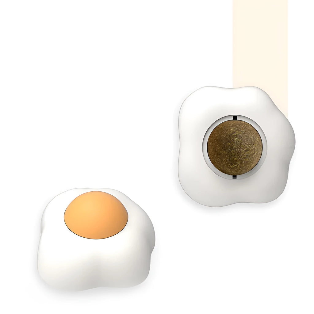 Soft plush catnip ball toy attached to wall for interactive feline play