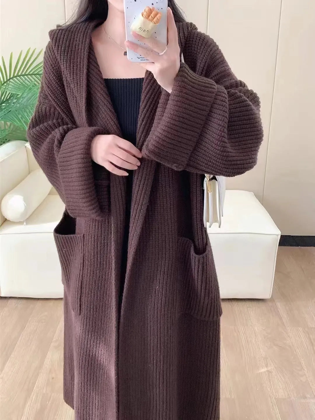 Loose hooded acrylic cardigan sweatshirt in milky white colour showing raglan sleeves and 80cm length