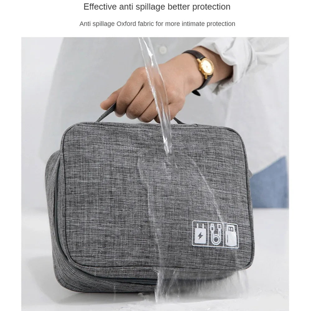 Black or grey waterproof travel cable organiser bag open to show mesh pockets and removable padded dividers