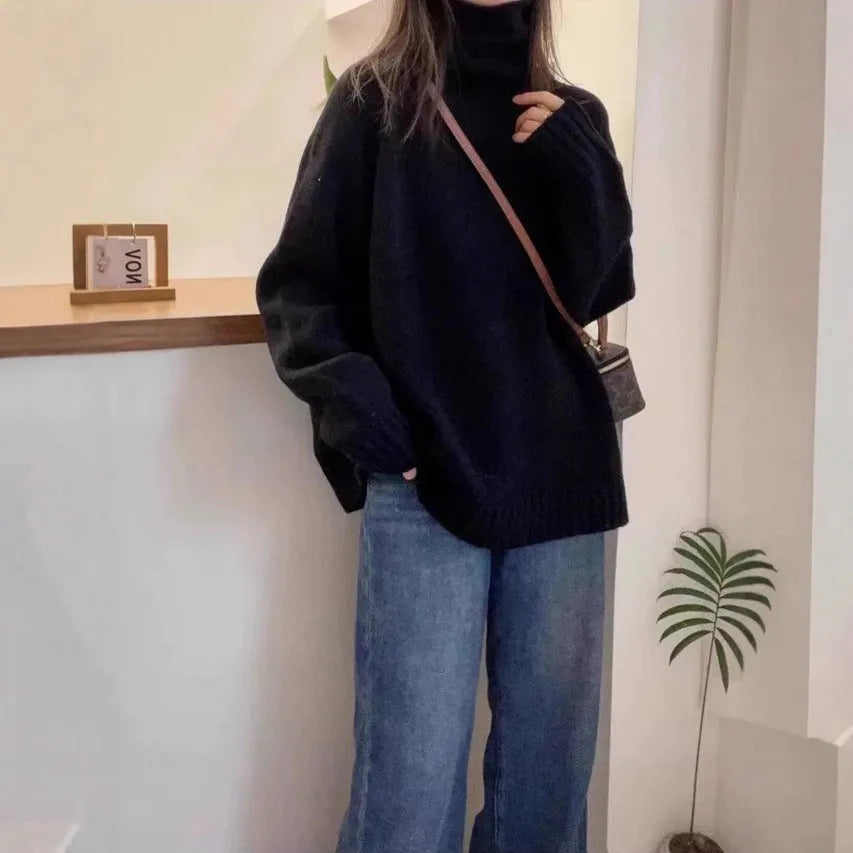 Women's loose-fit turtleneck sweater with a thick, textured curling pile collar in a grey solid colour.