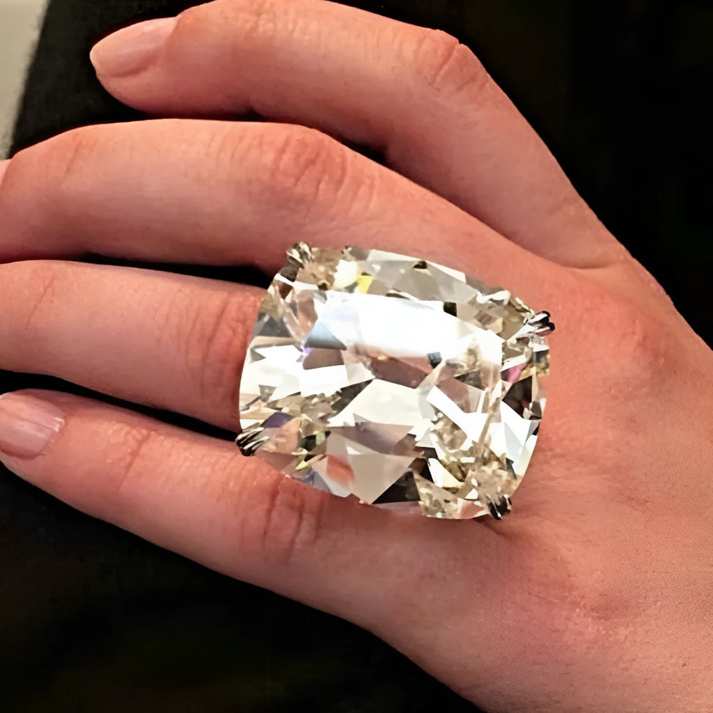 Women's simple inlaid white square diamond alloy ring with a geometric design on a finger.