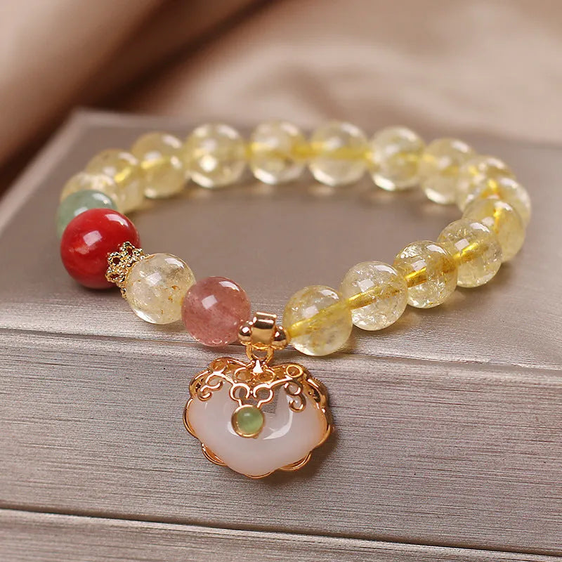 Women's bracelet with a yellow hair crystal jade ruyi pendant on an alloy chain.
