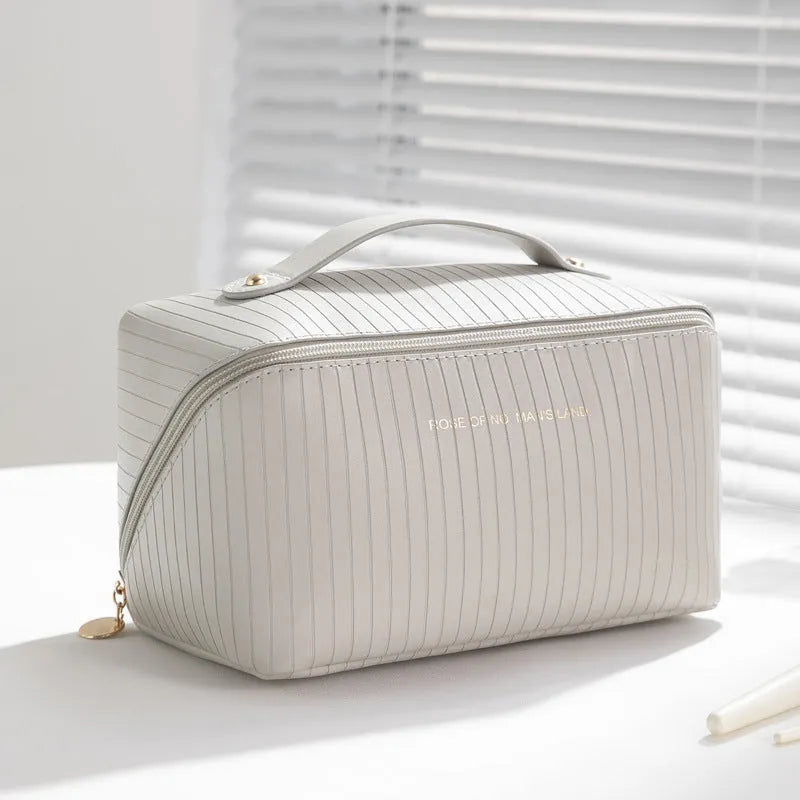 Cubic pillow makeup bag with vertical pattern in five colour options showing 22.5cm dimensions