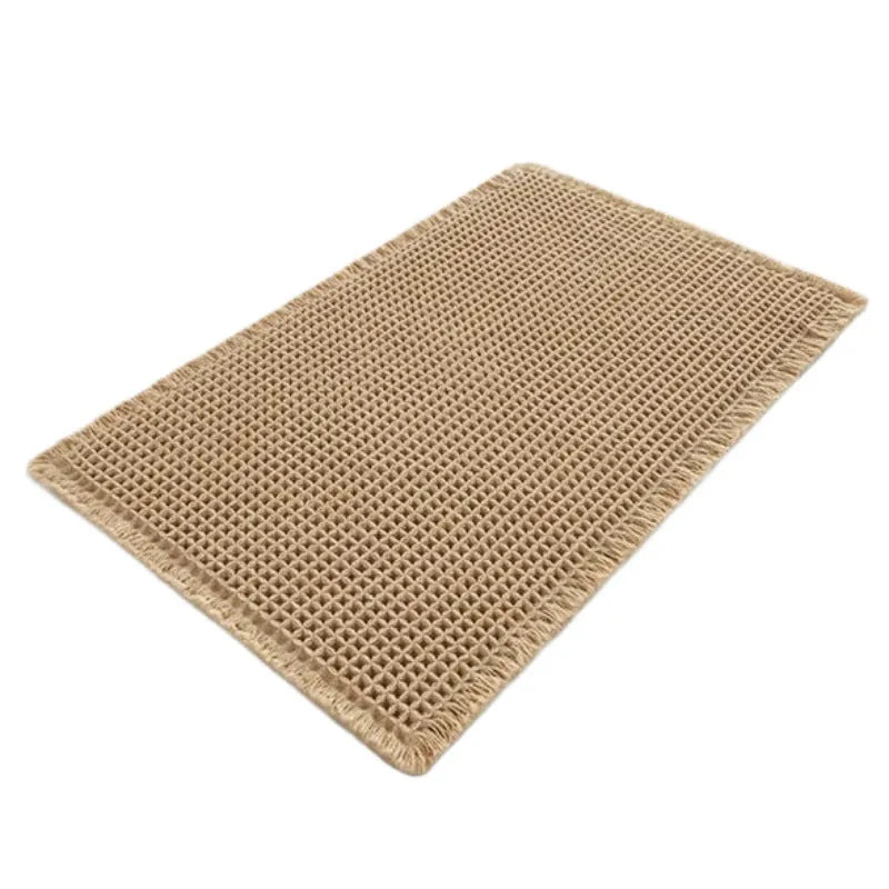 Modern checkered pattern absorbent non-slip bathroom floor mat in a neutral colour on tiled floor.