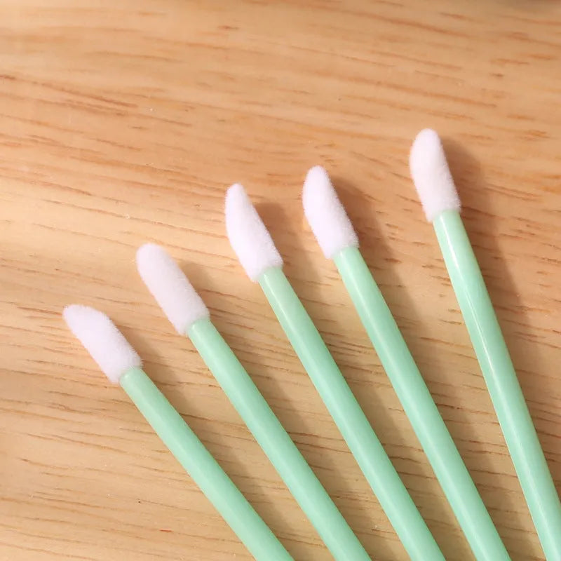 Disposable lip brushes with flocked heads and black handles in various colours