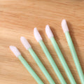Disposable lip brushes with flocked heads and black handles in various colours