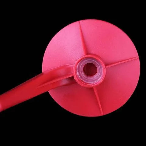 Red plastic Magic Tap soda dispenser attached to inverted 2 litre bottle