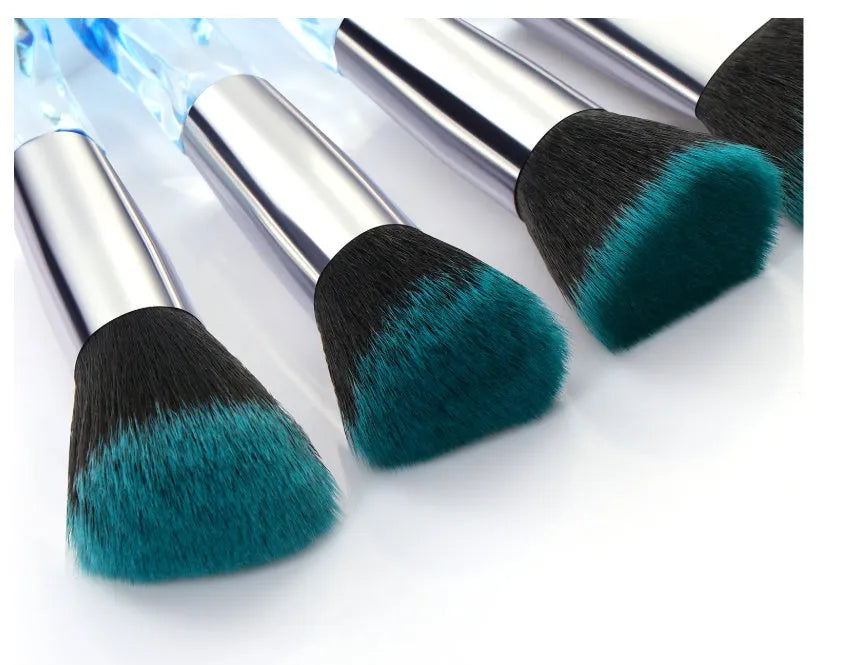 Ten clear crystal diamond shank foundation brushes with artificial fibre heads, shown in a set.