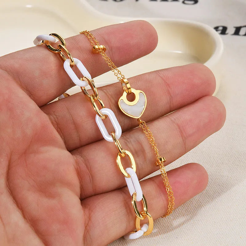 Women's stainless steel bracelet with a double-layered resin heart shape and electroplated finish.