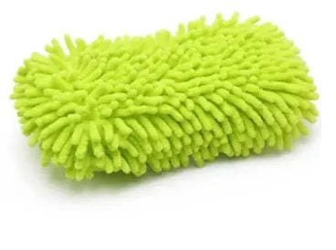 Silver green rectangular car wash sponge block on a clean surface