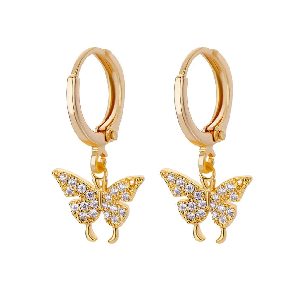 Close-up of women's geometric butterfly drop earrings with heart, star, and bow shapes in copper.