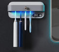 White wall-mounted smart toothbrush sterilizer holder with UV light and USB port.
