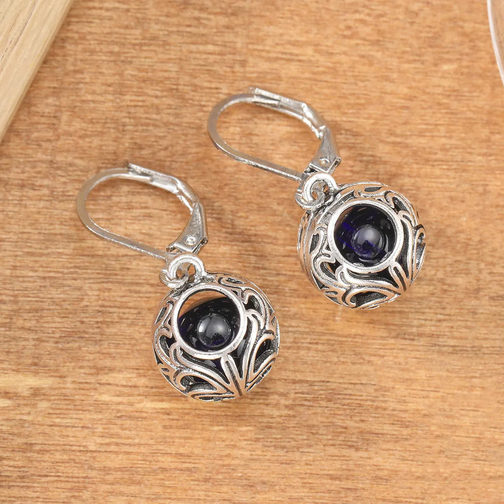Vintage geometric silver tone pendant earrings with hollow blue gemstone setting