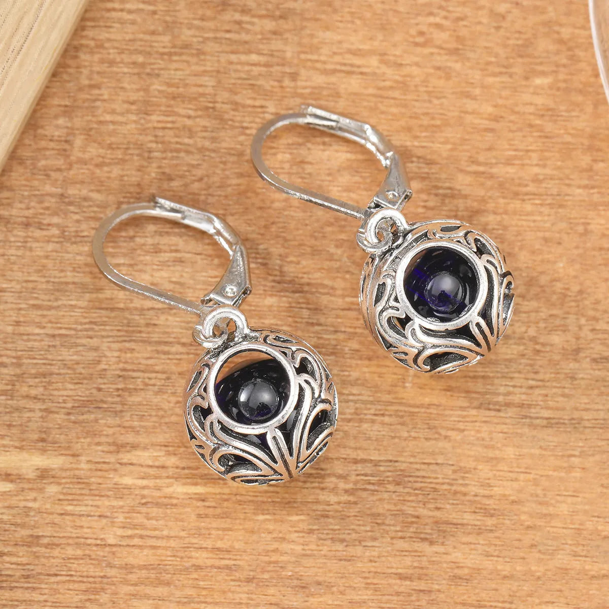 Vintage geometric silver tone pendant earrings with hollow blue gemstone setting