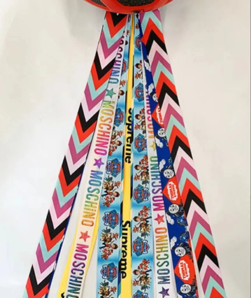 Children's decorative helmet streamer ribbon in multiple colours for roller skating and skiing safety gear.