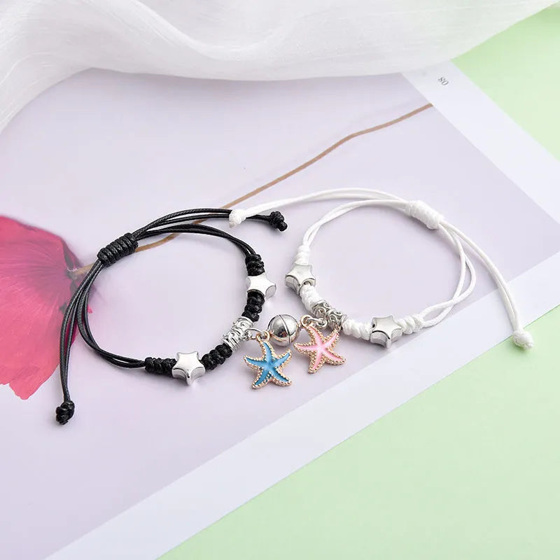 Alloy couple bracelets with magnet closure showing various design options including crown, clover, and text patterns