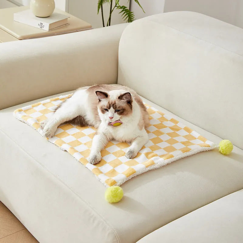 Plaid pattern pet blanket with fur ball trim on soft cotton fleece material for cats and dogs