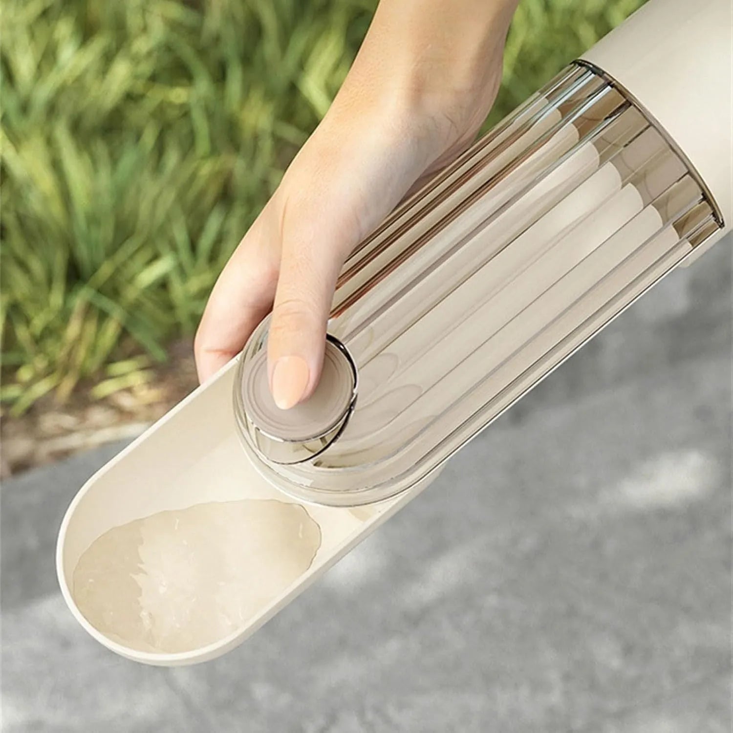 Beige and green foldable dog water bottle with food dispenser for outdoor use