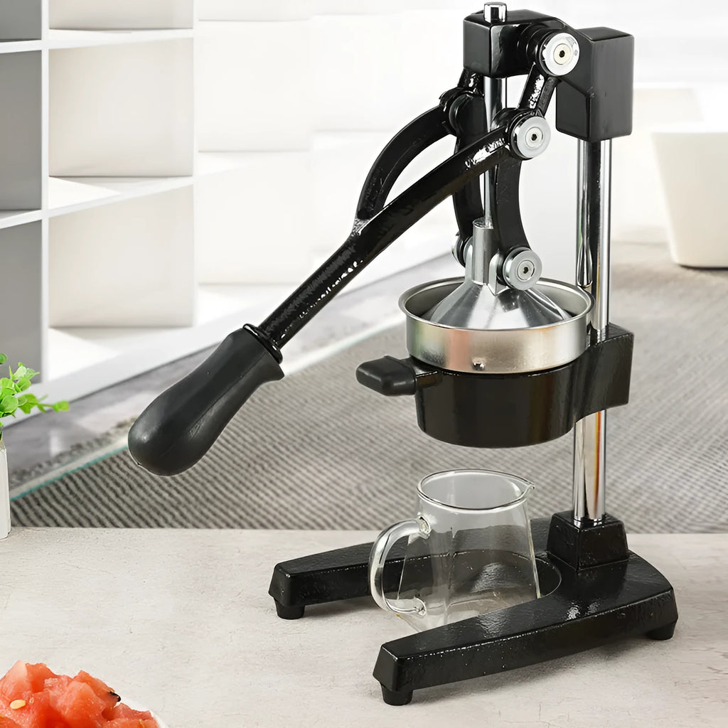 Black and white cast iron manual citrus juicer with stainless steel strainer, 40cm tall.