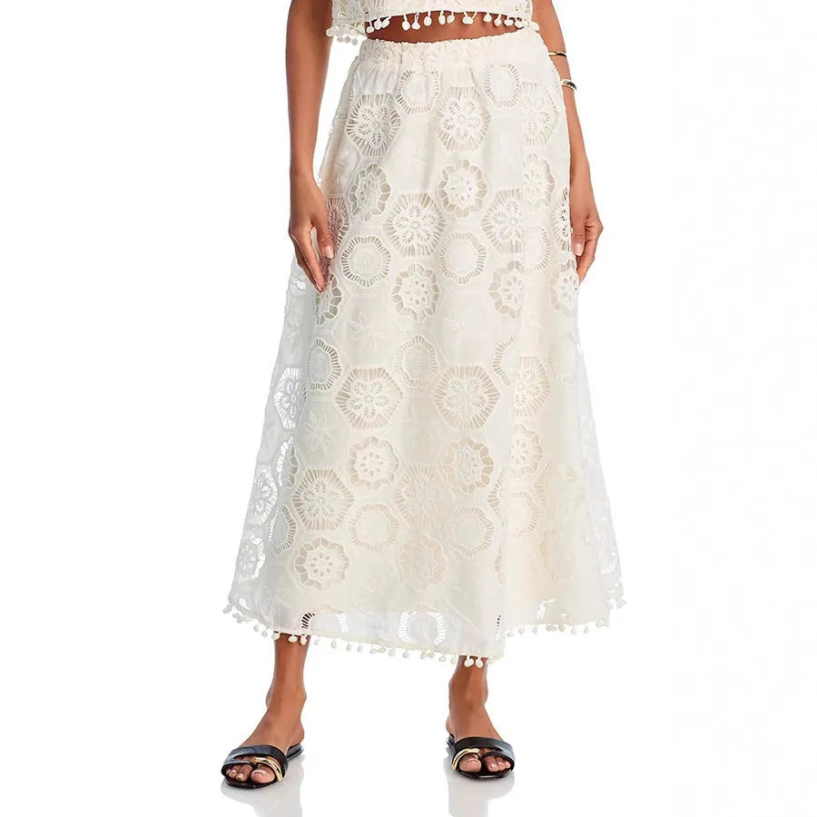 White women's retro style embroidered two-piece suit with sleeveless top and long skirt