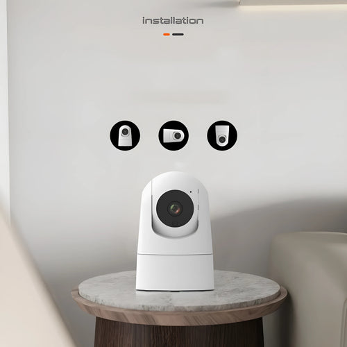 White indoor PTZ security camera with lens and mounting bracket on table