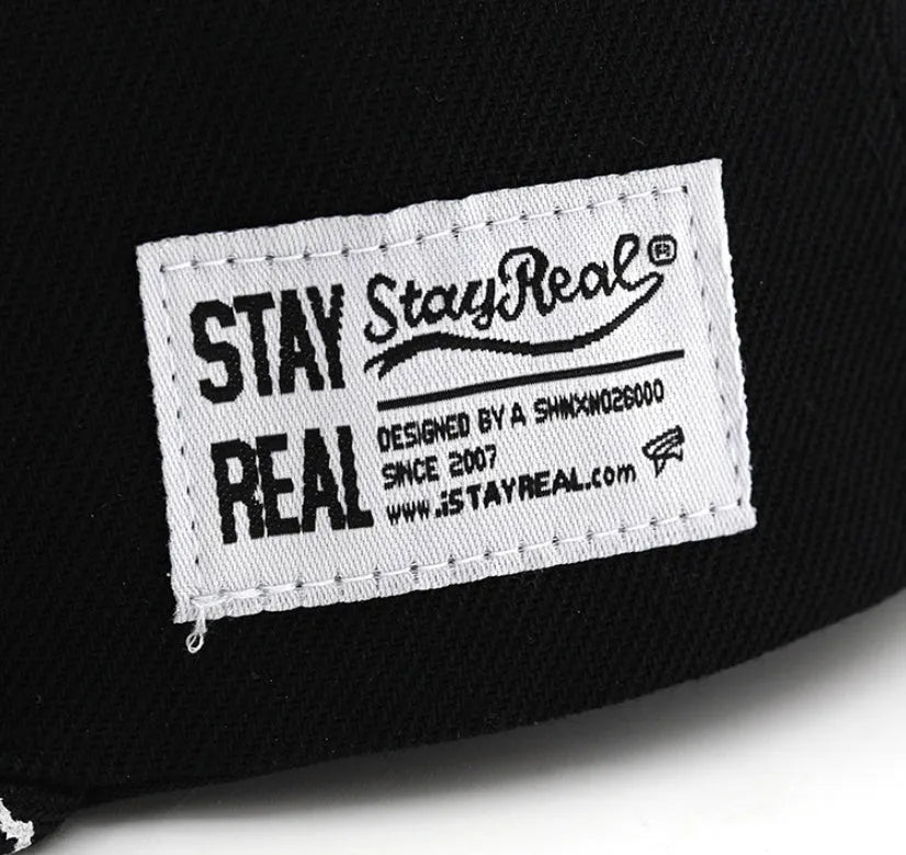 Cotton baseball hat with embroidered letters on a dome crown, shown in black and white.