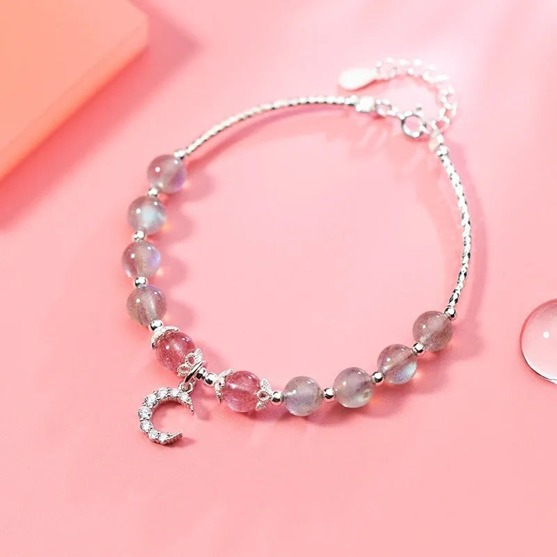 Handmade silver-tone adjustable bracelet with a 6mm moonstone bead and a small crescent moon charm.