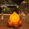 Small Fire Pile cartoon-themed silicone night light with yellow glow on a table.