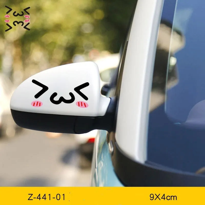 A pair of reflective cartoon eye car stickers on a vehicle rearview mirror.