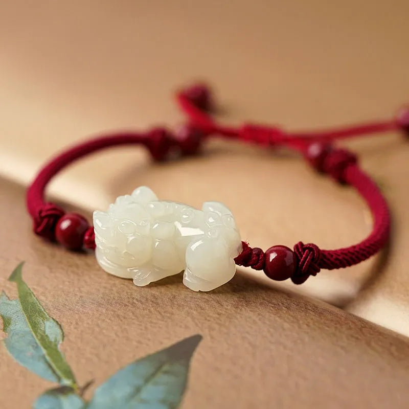 Hetian Jade bracelet with a black and red braided rope band and a central jade bead.