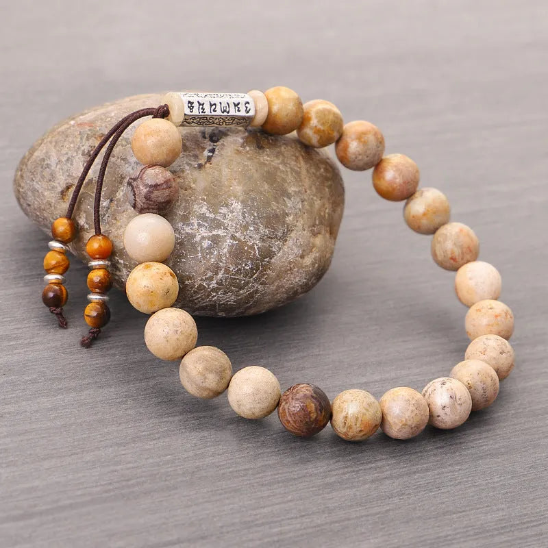 Handmade wood colour stone bead bracelet with retro design on a wrist