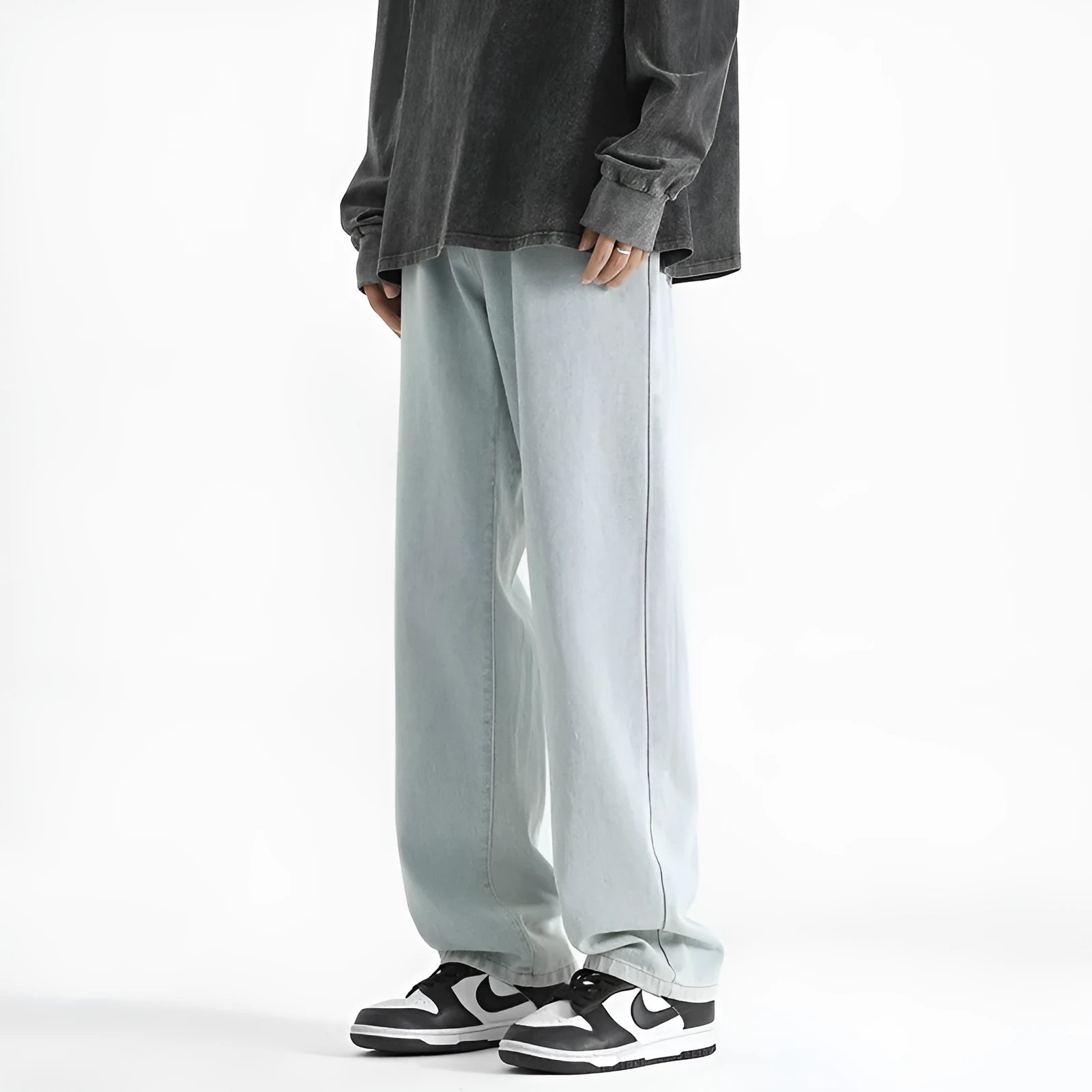Men's light blue straight leg jeans with a button waist, laid flat.
