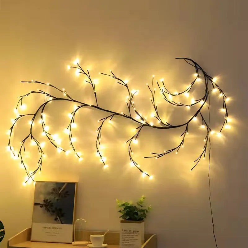 Flexible LED willow vine garland with warm white lights on birch-textured branches for wall and party decor.