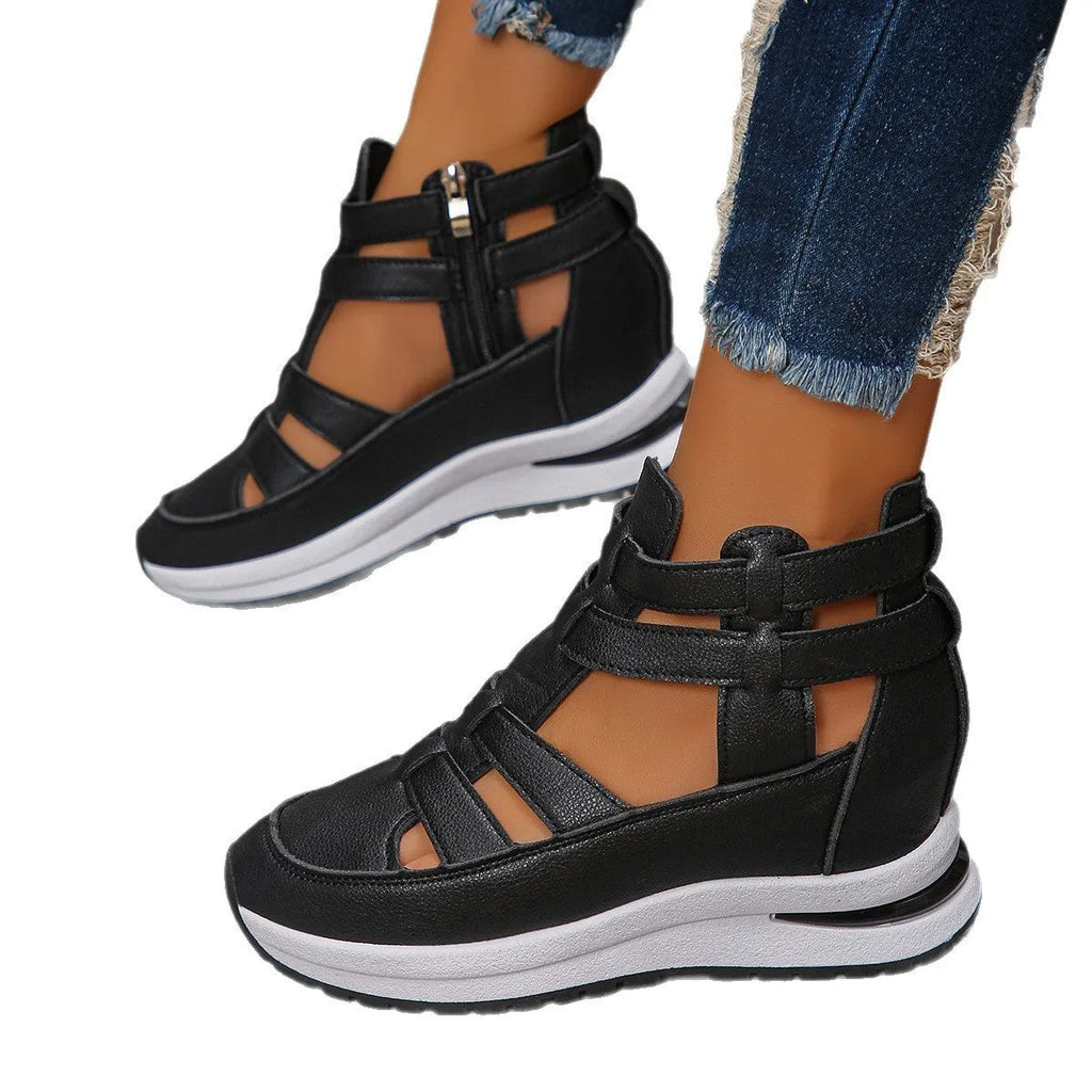 Women's black close-toed hollow-out platform sandals with a Velcro strap on a white background.