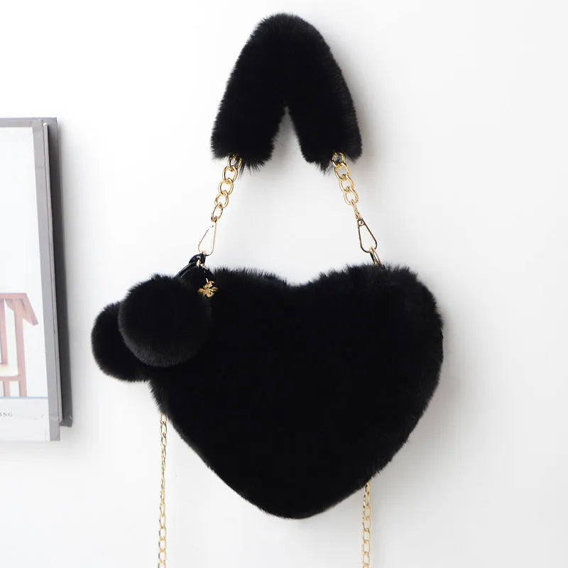A soft plush heart-shaped women's handbag with a zipper and a detachable shoulder strap in a choice of 14 colours.