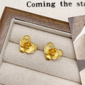 Retro flower earrings in gold or silver with detailed petal design on copper base
