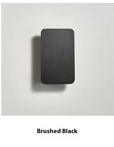 Minimalist modern LED wall lamp in black finish mounted on a wall
