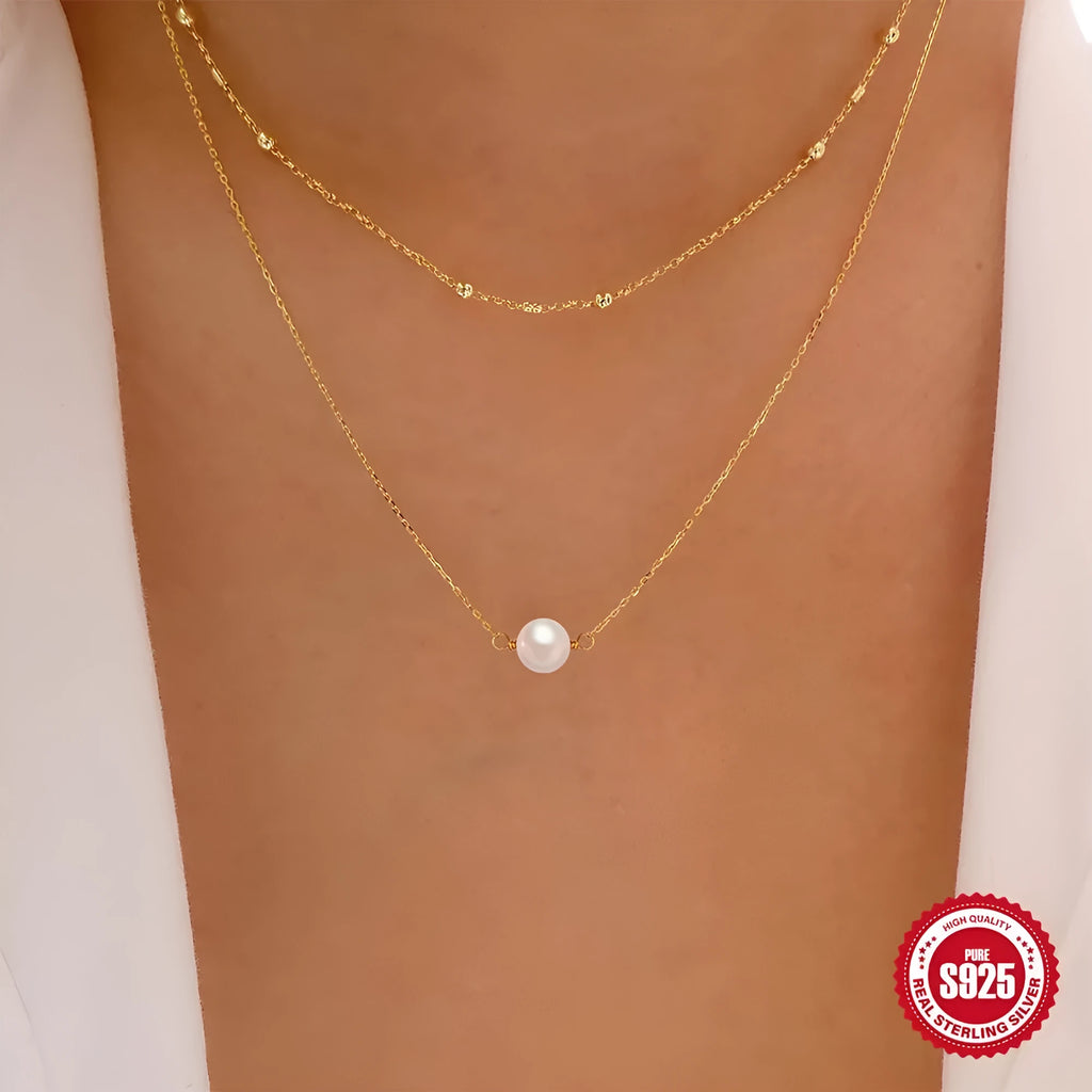 S925 sterling silver double layer necklace with twin pearls on a geometric pendant, shown in gold and white gold finishes.