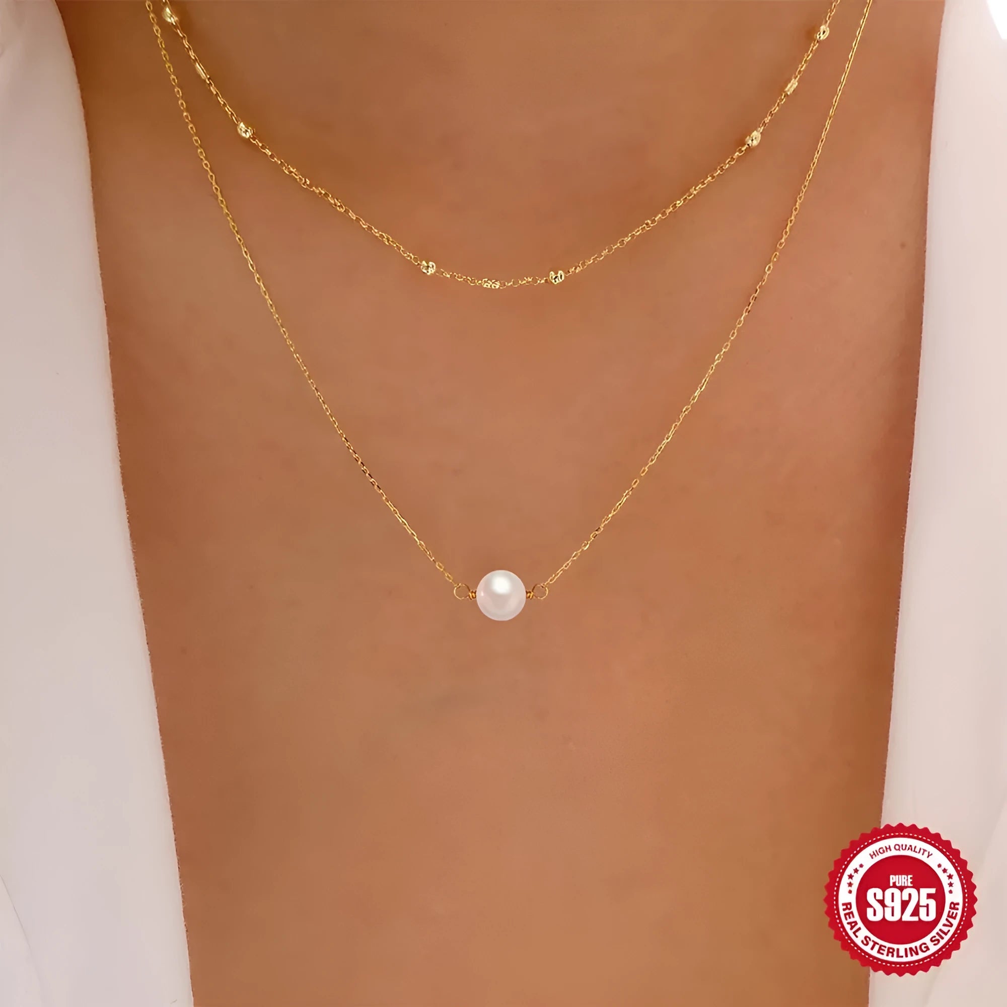 S925 sterling silver double layer necklace with twin pearls on a geometric pendant, shown in gold and white gold finishes.