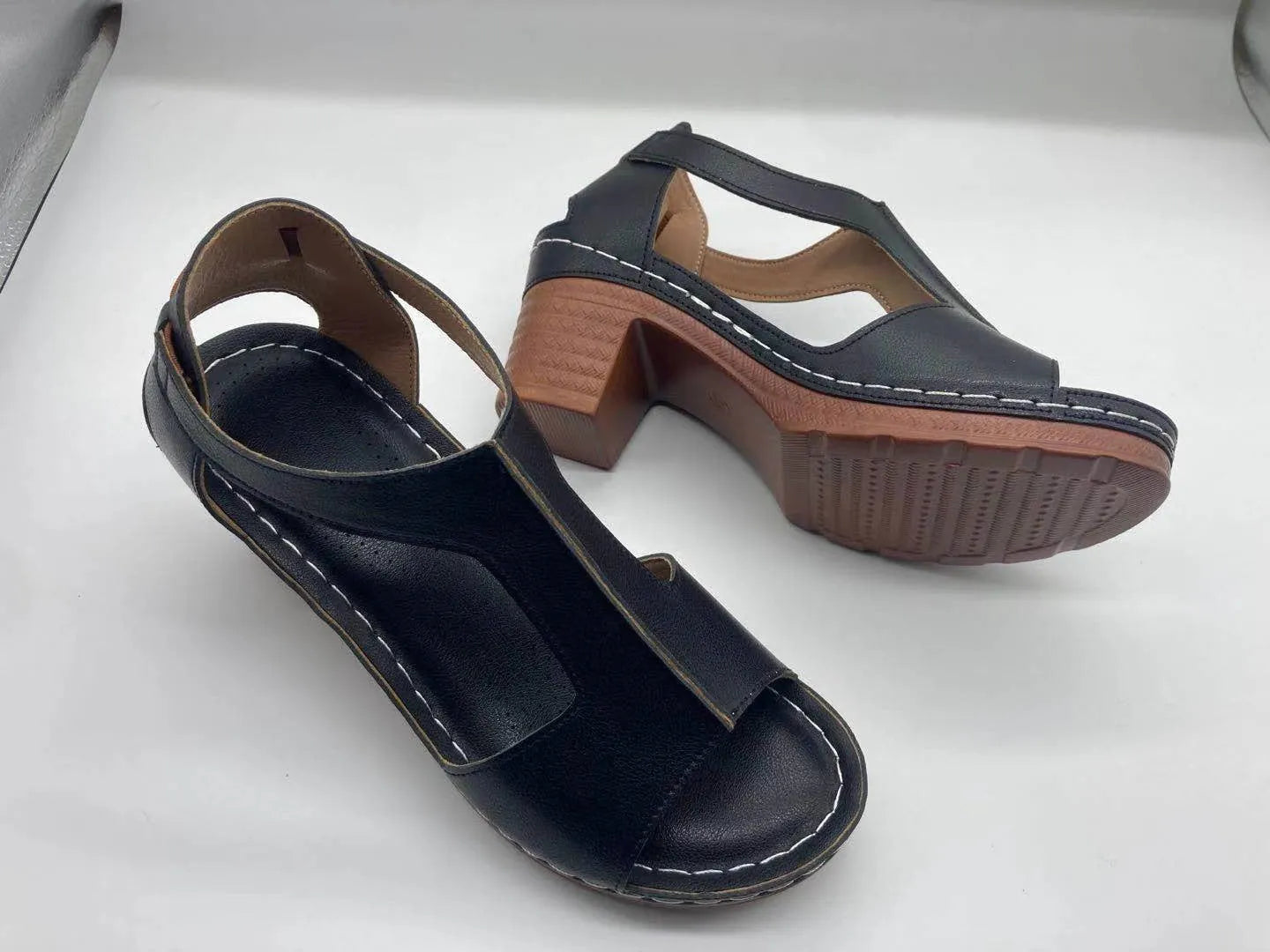 Women's peep toe wedge sandals with a buckle strap, shown in a light brown colour on a white background.