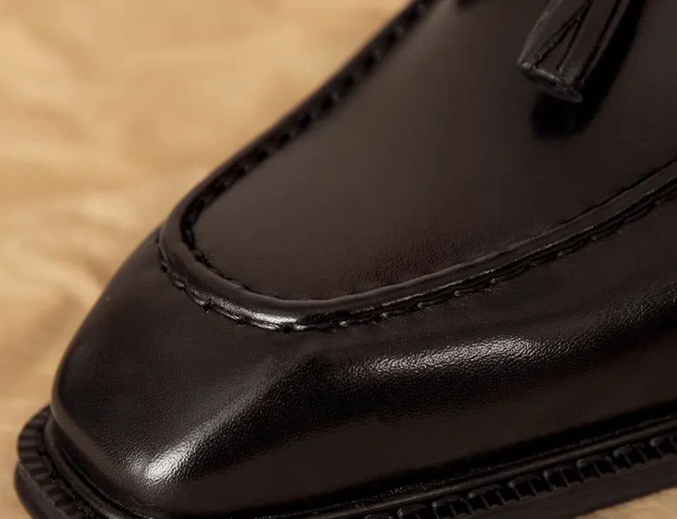 Men's black genuine leather slip-on loafers with a polished finish and rubber sole
