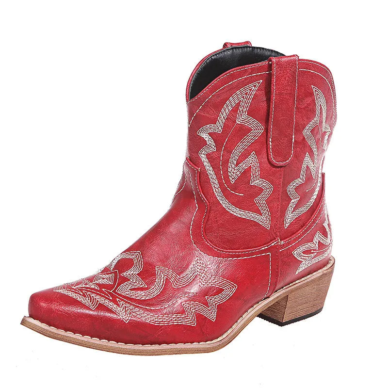 Women's blue embroidered cowboy boots with low wedge heel and pointed toe on a white background.